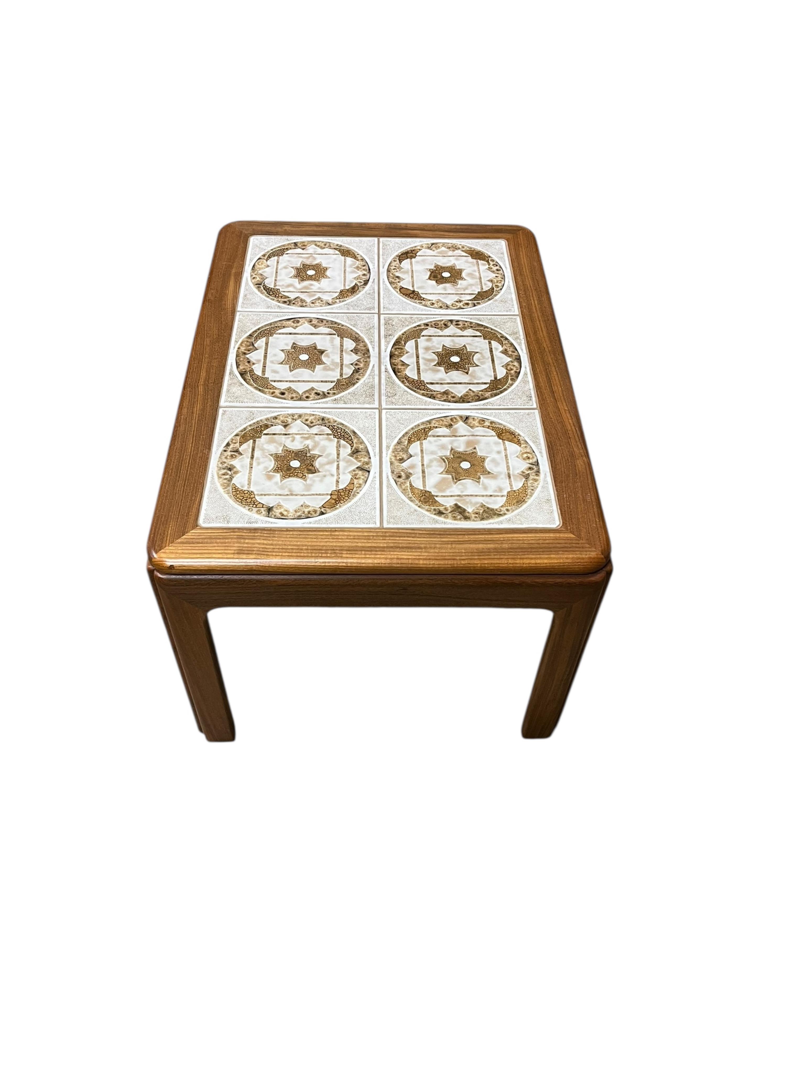 A mid century G Plan tile top teak coffee table and two matching occasional tables, larger width 134cm, depth 74cm, height 46cm